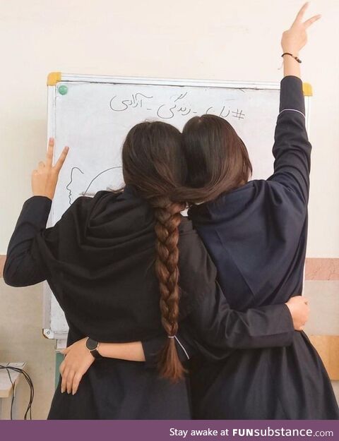 Two Iranian student girls celebrating the International Girls day