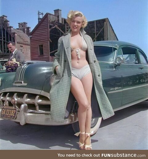 Marilyn Monroe poses for a portrait next to a 1950 Pontiac Chieftain in 1951