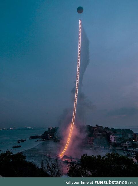 A Chinese artist created a 1,650-foot fireworks ladder in the sky, honoring his