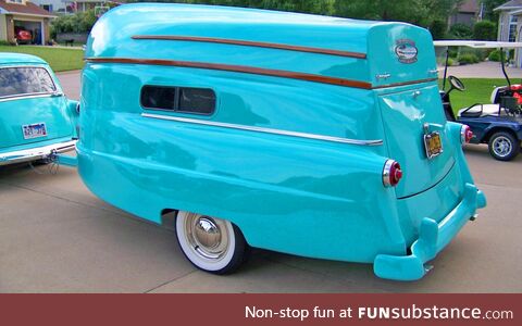 Vintage camper with matching row boat