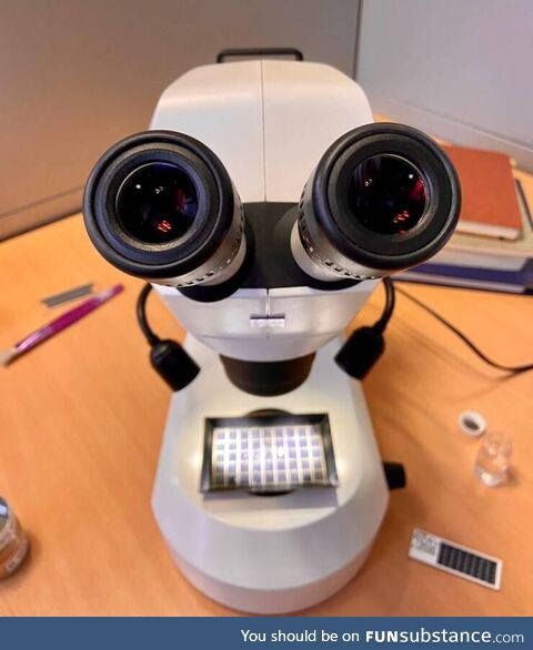 This microscope looks like a robot, with tiny hands and lips