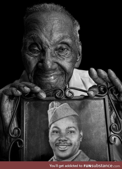 Lawrence Brooks, a 96-year-old World War II veteran holding a photo of himself taken