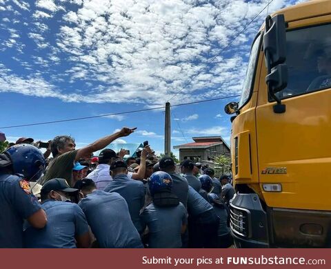 Residents in the Philippines set up a human barricade to stop illegal mining operations
