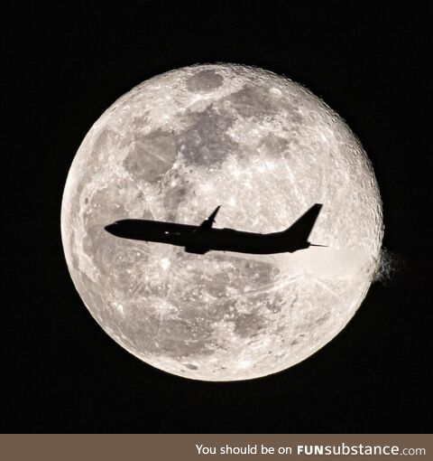Jet flying by full moon. Orlando, Florida