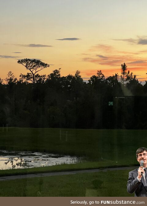 John oliver exploring swampy land under rainbow sky