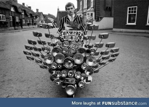 Bryn Owen aged 17 with his Vespa scooter, which has 34 mirrors and 81 lights on the front