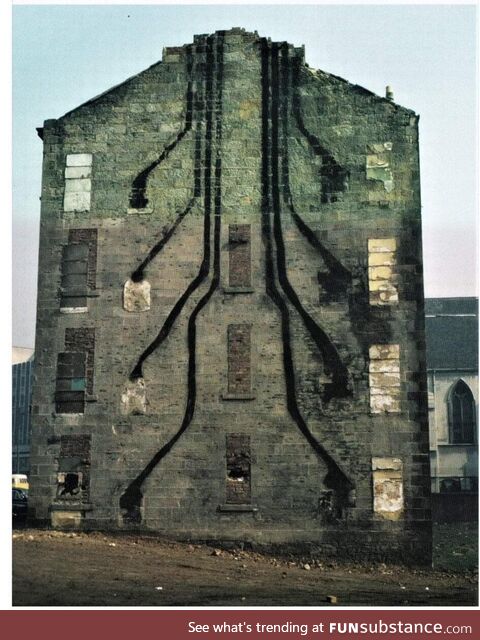 A Glasgow tenement building during demolition, 1972, showing soot trails to chimneys