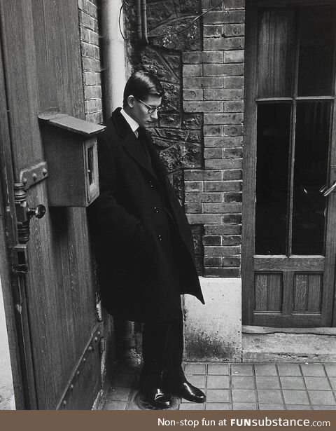 Yves Saint Laurent standing alone at his mentor, Christian Dior's funeral