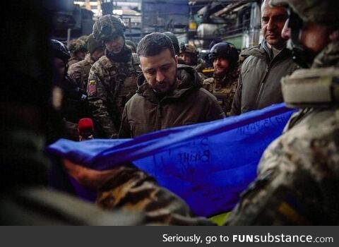Zelensky is given a flag signed by the heroes of Bakhmut to give to America as a thank