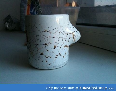 Coffee leaking out the cracks of a mug