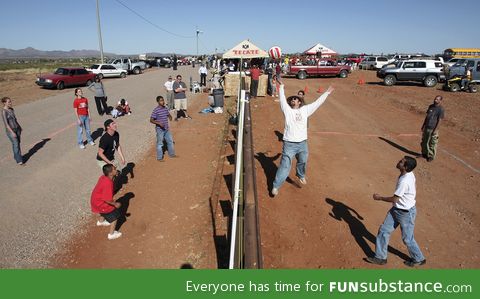 Americans and mexicans playing volleyball over the border in arizona