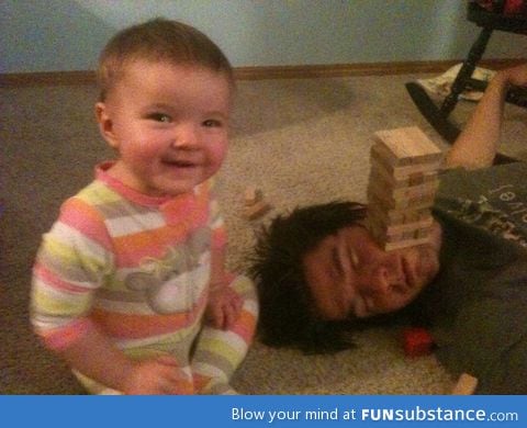 Husband fell asleep so daughter and I started playing jenga on his face